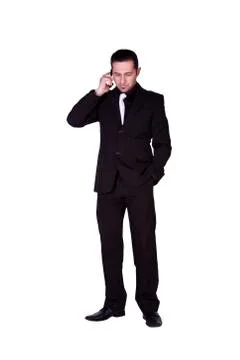 Businessman looking down while talking on the phone Stock Photos