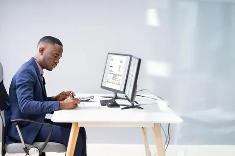 Businessman Looking At Invoice On Computer Stock Photos