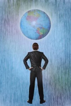 Businessman looking at a large globe Stock Photos