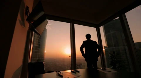 Businessman looking out the window in a contemplative way, Dolly shot, sunset Stock Footage 55842780