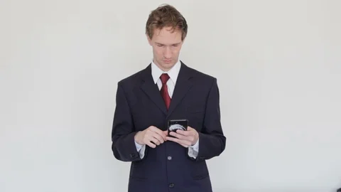 Businessman Looking At The Phone Screen Gets awful news and become angry. Stock Footage 129625393