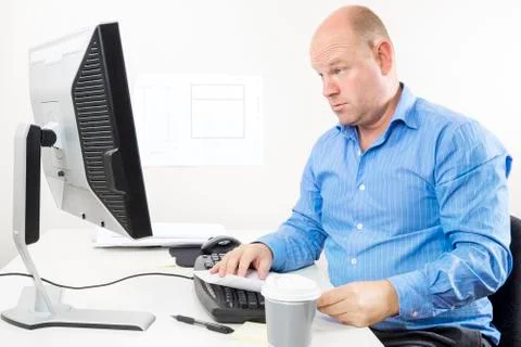 Businessman looking questioning at the computer screen Stock Photos