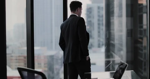 Businessman looking up at skyscraper thinking Stock Footage 99023432