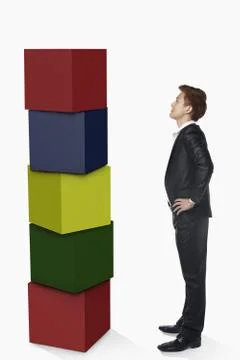 Businessman looking at a stack of cubes Stock Photos