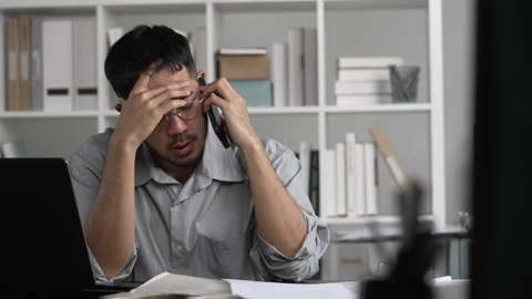 Businessman looking stressed while talking phone Stock Footage 317753567