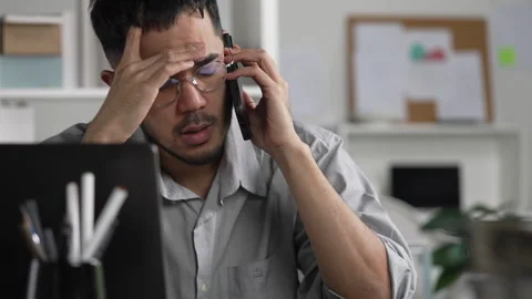 Businessman looking stressed while talking phone Stock Footage 317754731