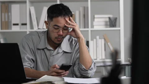 Businessman looking stressed while using phone Stock Footage 317753819