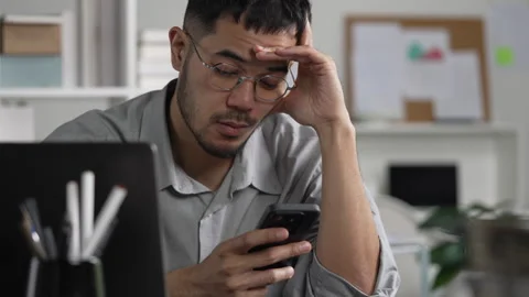 Businessman looking stressed while using phone Stock Footage 317754308