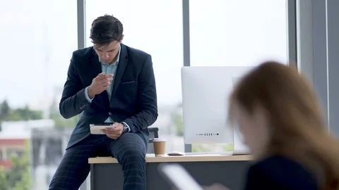 Businessman looking at a tablet in the office Stock Footage 98003463