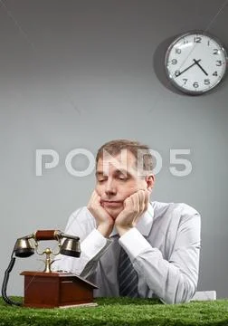 Businessman looking at telephone and expecting call Stock Photos