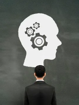 Businessman looking at thinking brain graph Stock Illustration