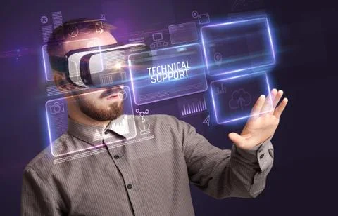 Businessman looking through Virtual Reality glasses, tech concept Stock Photos