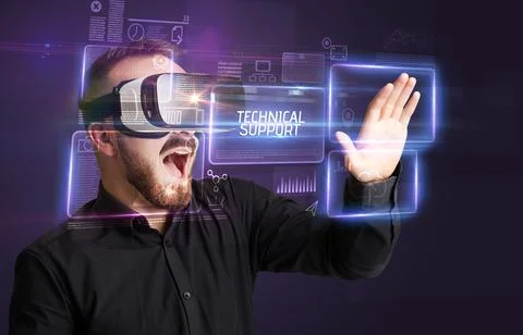 Businessman looking through Virtual Reality glasses, tech concept Stock Photos