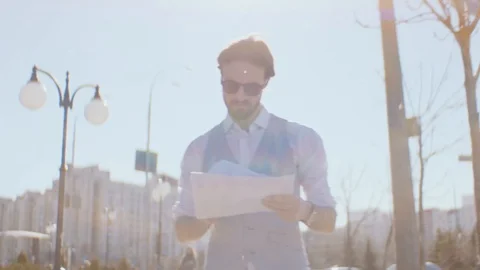 Businessman looks through documents walking around the city Stock Footage 128526262