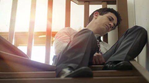 Businessman lost in his problems sitting on the stairs: defeated businessman Video stock 51418086