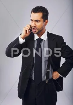 Businessman mad at someone over the phone Stock Photos