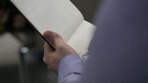 Businessman makes notes in a notebook. Shooting in the studio on a black Stock Footage 143992206