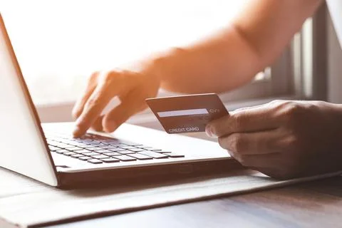 Businessman makes a purchase on the Internet on the computer with credit card Stock Photos