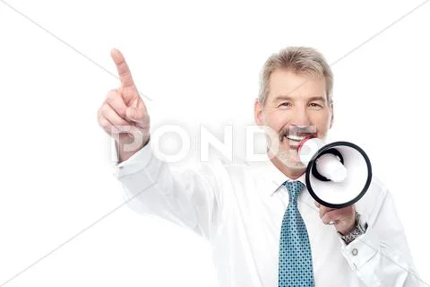 Businessman making an announcement by loudhailer Stock Photos