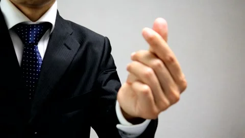 A businessman making a heart shape with his fingers Stock Footage 335664147
