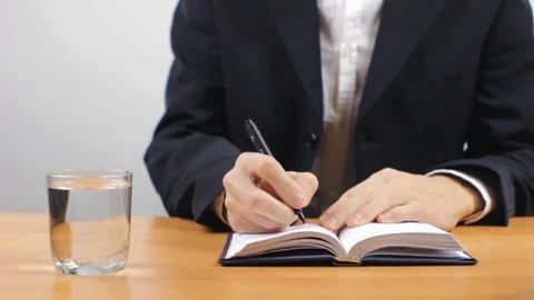 Businessman Making Notes and Drinking Water Stock Footage 81860366