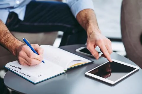 Businessman making notes in notebook Stock Photos