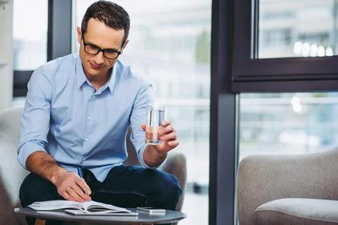 Businessman making notes in notebook Stock Photos