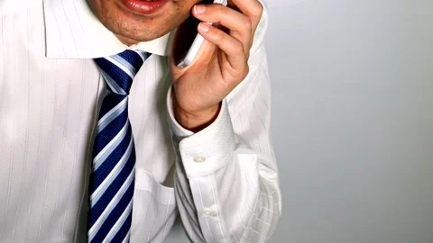 A businessman making a phone call using his smartphone. Stock Footage 334775613