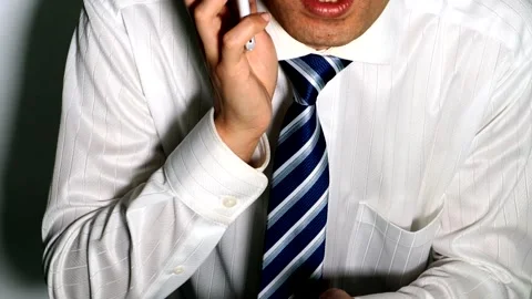 A businessman making a phone call using his smartphone. Stock Footage 334776260
