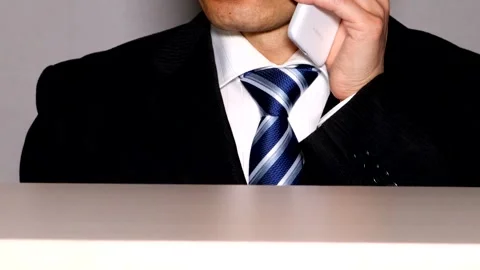 A businessman making a phone call using his smartphone. Stock Footage 334837088