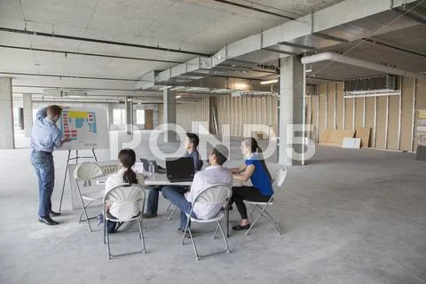 Businessman Making Presentation To Colleagues