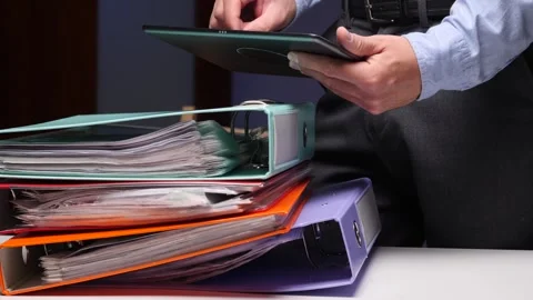 Businessman managing office paperwork and data with tablet Stock Footage 322912341