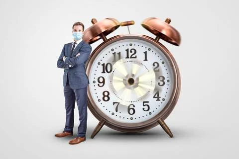 Businessman with a mask standing next to a clock with spinning hands Stock Photos