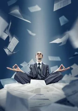 Businessman is meditating with documents Stock Photos