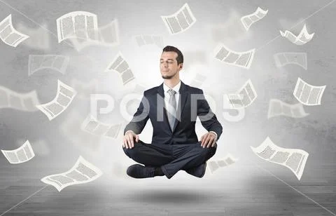 Businessman meditating with flying paper concept Stock Photos