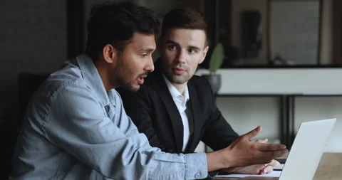 Businessman mentor helps to young apprentice with report preparation Stock Footage 241750293