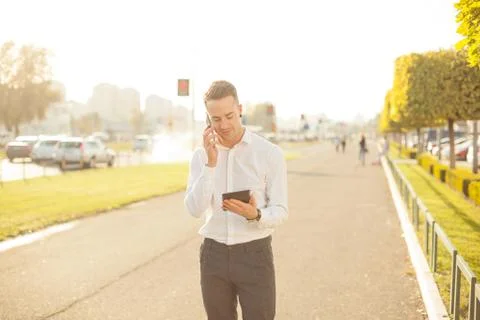 Businessman with mobile phone tablet in hands Stock Photos