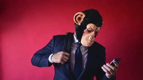 Businessman with monkey mask looking at camera Stock Footage 169412130