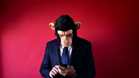 Businessman in monkey mask using smart phone. 스톡 동영상 169412147