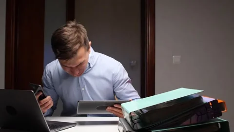 Businessman multitasking with multiple devices experiencing information overload Stock Footage 322911479