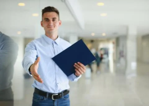 Businessman offer hand to shake as hello in office Stock Photos