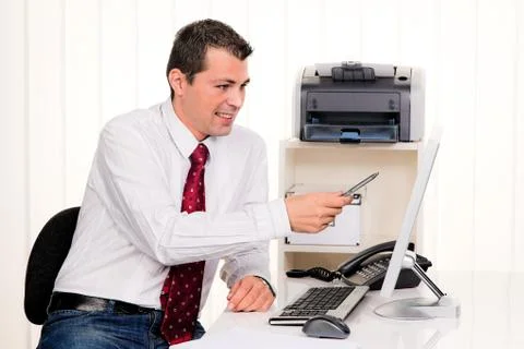 Businessman in office with a computer Stock Photos
