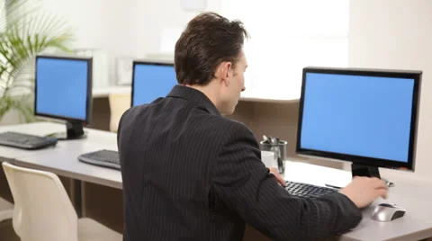 Businessman in office with computers Video stock 61668058