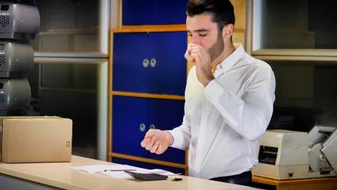 Businessman in office drinking coffee while working Stock Photos