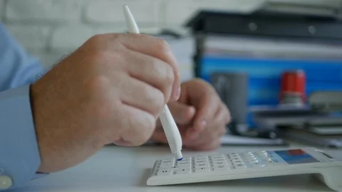Businessman in Office Make Calculations Using Adding Machine and a Pen Stock Footage 108794648