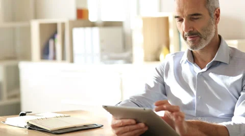 Businessman in office using digital tablet Stock Footage 37826405