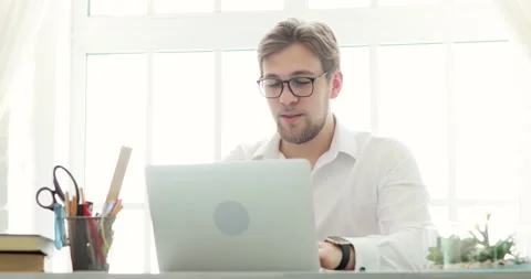 Businessman office worker is working typing on laptop at table in modern office. Video stock 131859186