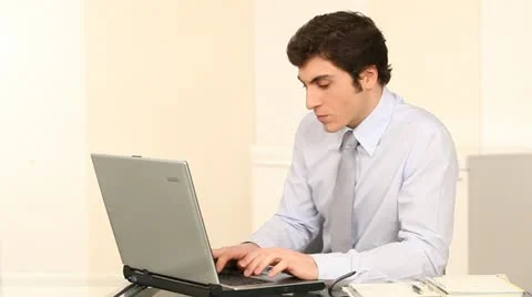 Businessman in office working on laptop computer Stock Footage 14832166