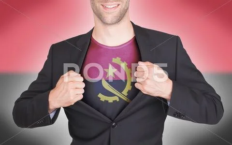 Businessman opening suit to reveal shirt with Angola flag Stock Photos