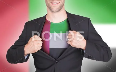 Businessman opening suit to reveal shirt with flag Stock Photos